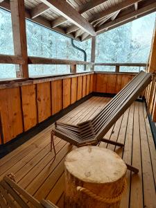 a bench sitting on a deck in a cabin at Silver Lodge in Luosto +1 photo
