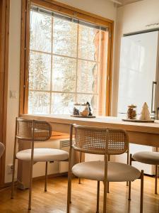 two chairs and a table in a kitchen with a window at Silver Lodge in Luosto