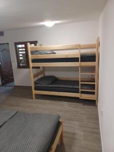 a room with three bunk beds in a room at Rekreačná chata TERASA in Železničná Stanica Šiatoroš +13 photos