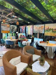 a restaurant with tables and chairs and ceilings with trees at Residence Villa Karda in Poreč