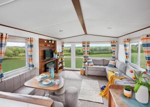 a living room with a couch and a table at Unity Beach in Brean