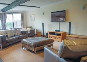 a living room with couches and a flat screen tv at Unity Beach in Brean +207 photos