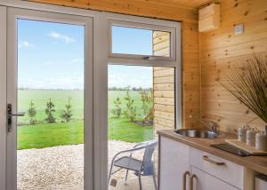 a kitchen with a door leading to a patio at Fine Country Stays in Bubwith