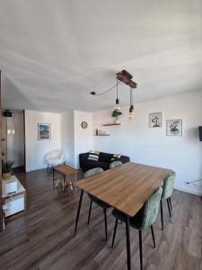 a living room with a table and a couch at Appartement Pila - Faverges in Faverges