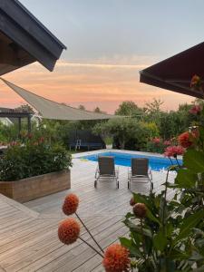 a patio with chairs and a pool in a house at Enplansvilla med pool in Tyresö