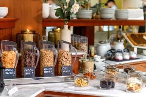 a display of cereals in glass containers on a counter at Vital Hotel Krainz mit Nebenhaus Familien Hotel in Loipersdorf bei Fürstenfeld