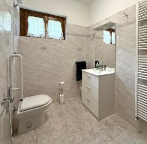 a bathroom with a toilet and a sink at La Casa nel Bosco in Arezzo +14 photos