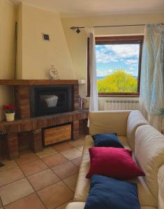 a living room with a couch and a fireplace at La Casa nel Bosco in Arezzo