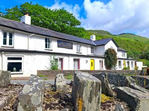 a white building with a fence in front of it at Pen-Y-Bont Hotel in Tal-y-llyn