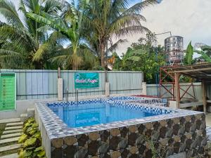 a pool with a bunch of bottled water in it at Itawis Resort - Ivanna's Room in Silang