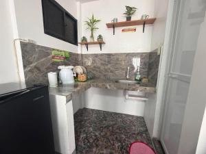 a small kitchen with a sink and a counter at Itawis Resort - Ivanna's Room in Silang