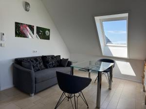 a living room with a couch and a glass table at Flat 39 in Wiehl