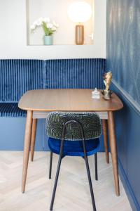 a wooden table and a chair in a room at L'ODE A PIERRE - Chambres d'hôtes in Dax