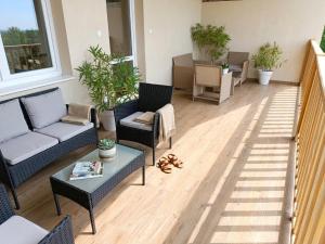 a living room with a couch and chairs and a table at Łapacz Mazurskich Chwil in Orzysz