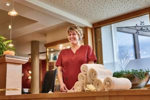 a woman standing behind a counter in a store at Hotel Kronelamm im Schwarzwald in Bad Teinach-Zavelstein +110 photos