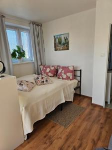 a small bedroom with a bed and a window at Blick auf die Kirche in Wschowa