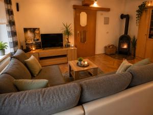 a living room with a large couch and a fireplace at Apartment Lagma in Železniki