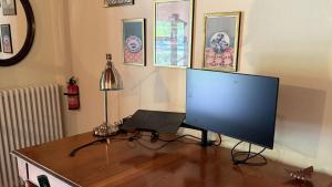 a computer monitor sitting on a desk with a laptop at Casa Ambrogina in Agliano Terme