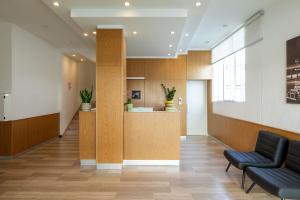 an office lobby with two chairs and a counter at Hotel Paradiso in Senigallia