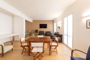 a living room with a wooden table and chairs at Hotel Paradiso in Senigallia