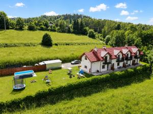 an aerial view of a house in a field at Willa Panorama 881-751-206 in Polańczyk