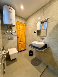 a bathroom with a toilet and a sink at French Woods Cottages in Srinagar