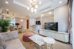 a living room with a couch and a table at The Fermin Premium Studios in Ho Chi Minh City