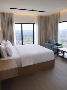 a bedroom with a large white bed and a chair at wifad Hotel in Al Namas +34 photos