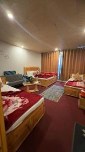 a bedroom with three beds in a room at Malam jabba Hotel reservation in Swat