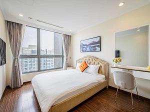 a bedroom with a large bed and a large window at The Fermin Premium Studios in Ho Chi Minh City