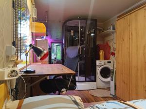 a room with a table and a washing machine at Unique and private summer apartment in Tartu