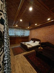 a bedroom with a bed and a couch in a room at French Woods Cottages in Srinagar