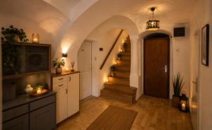 a hallway with an archway and a door and stairs at Apartment Lagma in Železniki