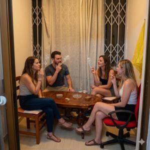 a group of people sitting around a table at Backpackers Durres in Durrës +33 photos