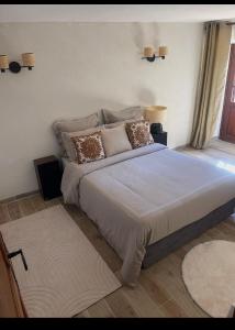 a bedroom with a large bed with pillows on it at Di colombie in Figari