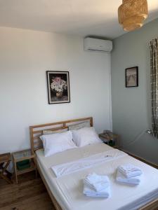 a bedroom with a bed with two towels on it at Greek sensation in Zagora