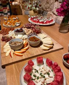 a table with many different types of cheese and fruit at Phisis Nature Retreat in Donoussa