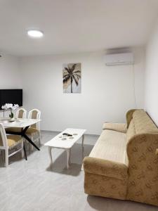 a living room with a couch and a table at Apartments Ana - Airport shuttle option in Podgorica