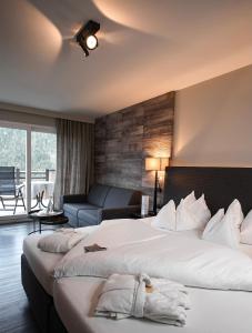 a hotel room with two beds and a couch at Boutiquehotel Friedrich in Nova Levante +38 photos