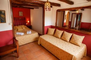 a bedroom with two beds and a mirror at Cal Gironell in Santa María de Meyá