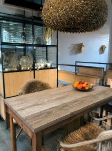 a wooden table with a bowl of fruit on it at Chalet Nest in Gravedona +26 photos