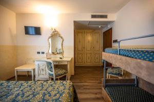 a room with two bunk beds and a mirror at Hotel Confine in Colà di Lazise +56 photos
