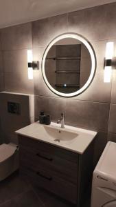 a bathroom with a sink and a mirror at Raptis House in Karavostamo