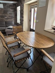 a table and chairs in a living room with a couch at SALT & SOUL in Senj