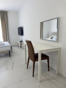 a white desk with a chair and a mirror at Mostoliva Sea View Studios in Pržno