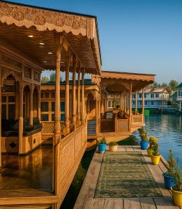a large wooden pavilion on a body of water at HAYAT Group OF Houseboats in Srinagar