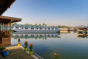a large boat is docked on a body of water at HAYAT Group OF Houseboats in Srinagar +8 photos