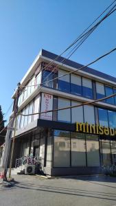 a building with a sign on the side of it at Em capsule Hostel Baku in Baku