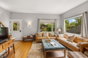 a living room with a couch and a tv at 7th Street Bungalow in Livingston