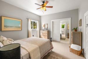 a bedroom with a bed and a ceiling fan at 7th Street Bungalow in Livingston